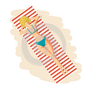 Young woman in bikini sunbathing lying on the beach