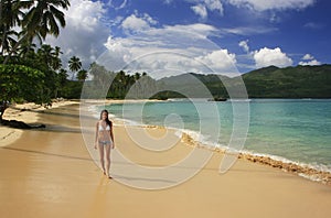 Young woman in bikini walking at Rincon beach, Samana peninsula photo