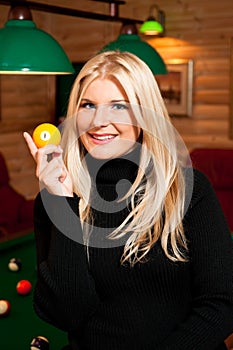 Young woman with billiard balls