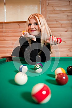 Young woman with billiard balls