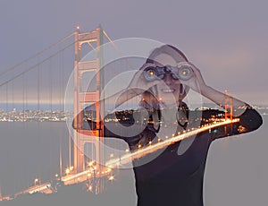 Young woman with binoculars near Golden Gate Bridge. Double expo