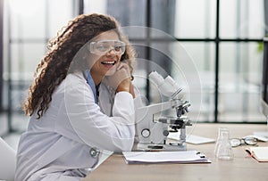 Young woman in biological laboratory. Attractive young female scientis.