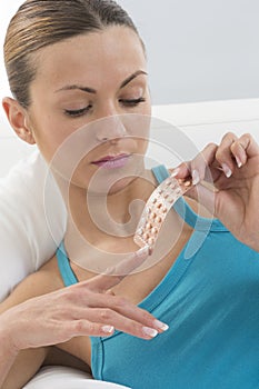 Young woman with birth control pills