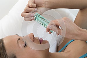 Young woman with birth control pills