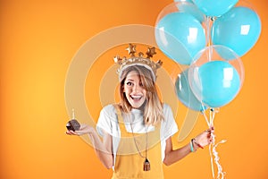 Young woman with birthday muffin