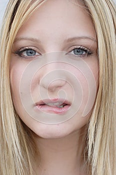 Young woman biting her lip