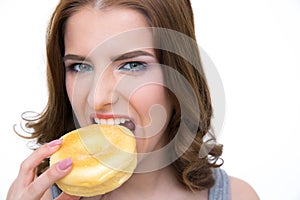 Young woman bitting doughnut