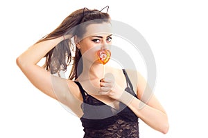 Young woman in black bra with candy