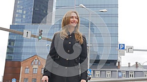 Young woman in black coat walking at the center