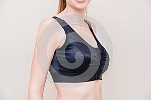 A young woman in black compression underwear after mammoplasty.