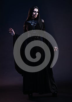 Young woman in black dress in Gothic style