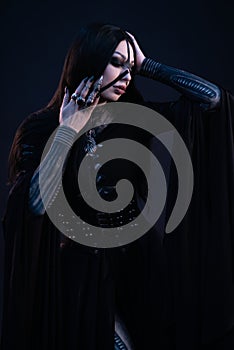 Young woman in black dress in Gothic style