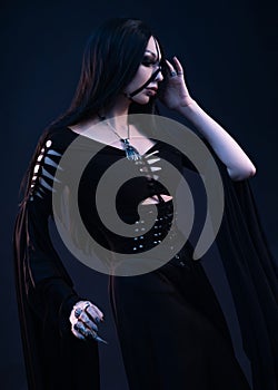 Young woman in black dress in Gothic style