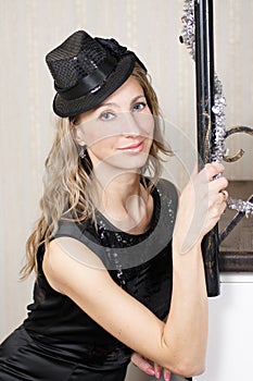 A Young Woman in Black Dress and a Hat