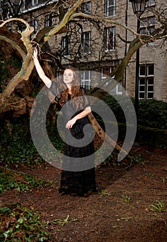 Young woman in a black dress in the park