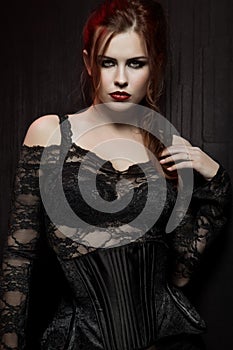 Young woman in black gothic costume