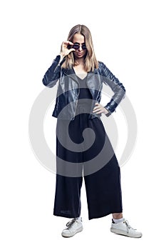 Young woman in a black leather jacket wearing black sunglasses. Style and fashion. Full height. Isolated on white background.