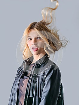 Young woman in a black leather rocker jacket.