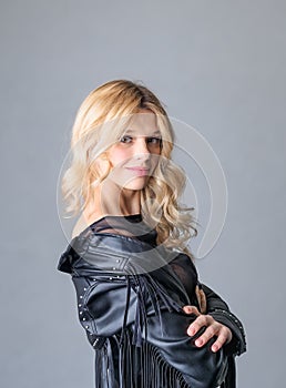 Young woman in a black leather rocker jacket.