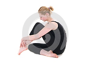 Young woman in black leotard sitting