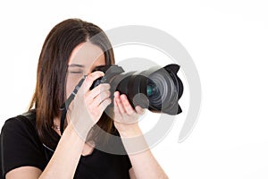 Young woman with black professional digital SLR camera on white background