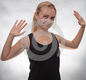 Young woman in black tank top with both hands open