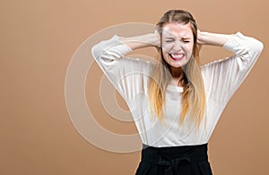 Young woman blocking her ears