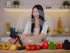 young woman is blogging for her kitchen