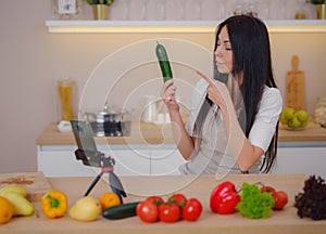 young woman is blogging for her kitchen