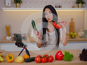 young woman is blogging for her kitchen