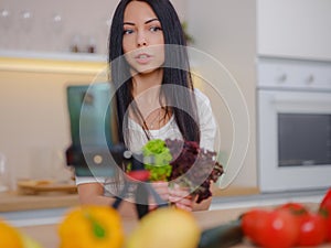 Young woman is blogging for her kitchen