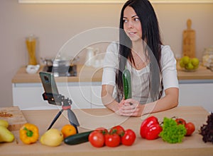 young woman is blogging for her kitchen