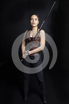 Young woman in urban fantasy poses on a black background photo