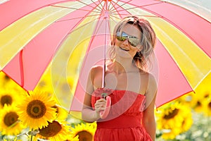 Young woman on blooming sunflower field