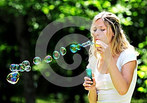 Young woman blowing bubbles