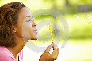 Young woman blowing bubbles