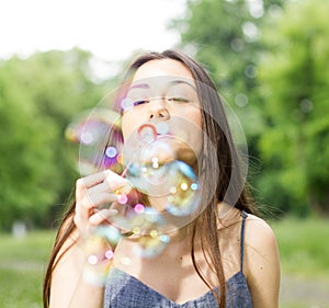 Young Woman Blowing Bubbles