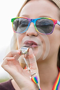 Young Woman Blowing Whistle On Gay Pride Parade
