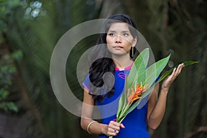 Young Woman in Blue Ao Dai Holding Flowers