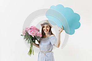 Young woman in blue dress, hat holding blank empty say cloud, speech bubble with place text, bouquet of pink peonies