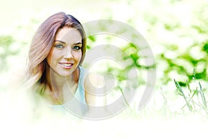 Young woman in blue dress lying on grass