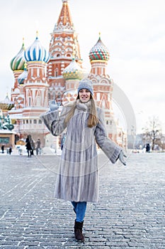 Young woman in a blue knitted hat and gray mink coat