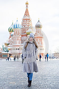 Young woman in a blue knitted hat and gray mink coat