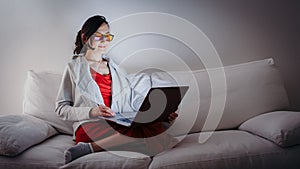 Young woman with blue light blocking glasses yellow lenses