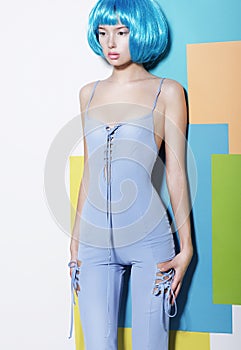 Young Woman in Blue Overalls and Creative Wig