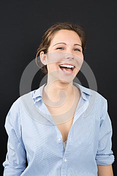 Young woman in blue shirt laugh and smile