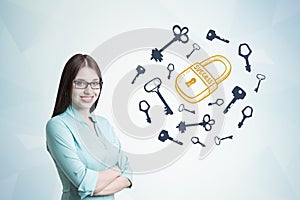 Young woman in blueish shirt, key and lock