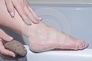 Young woman,Body care,woman having her foot scrubbed by brush