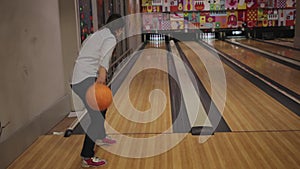 young woman is bowling. Indoors, sports game, heavy balls. Special shoes, rookie. sadness