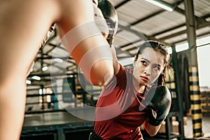 young woman boxer hitting punching competing with her opponent